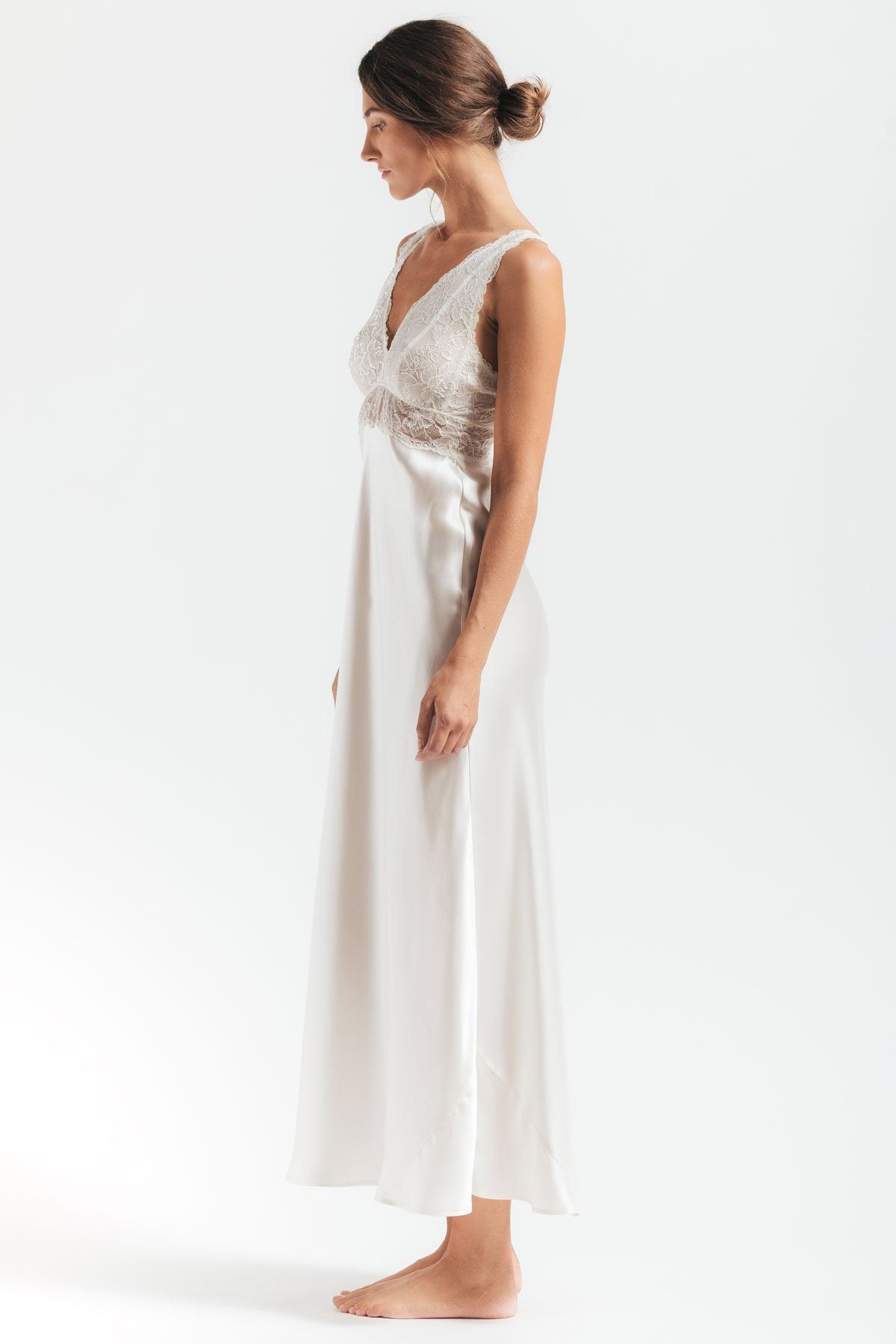 Sideview of model wearing Morgan iconic Bust-support white silk gown in Ivory