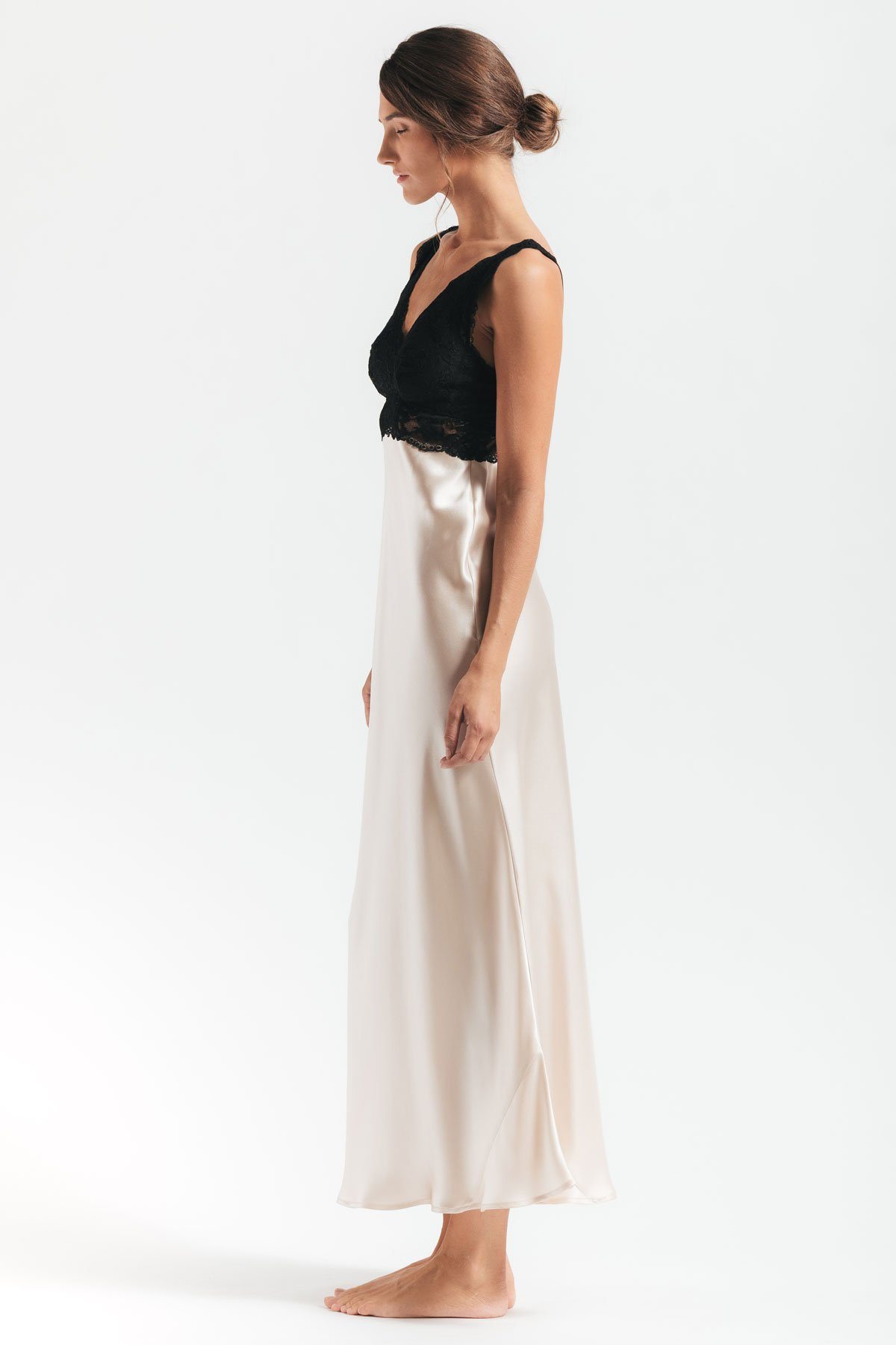 Side profile of model wearing Morgan Iconic Bust-Support silk gown in champagne